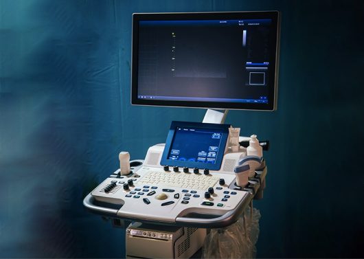 an image of an ultrasound machine and wall monitor